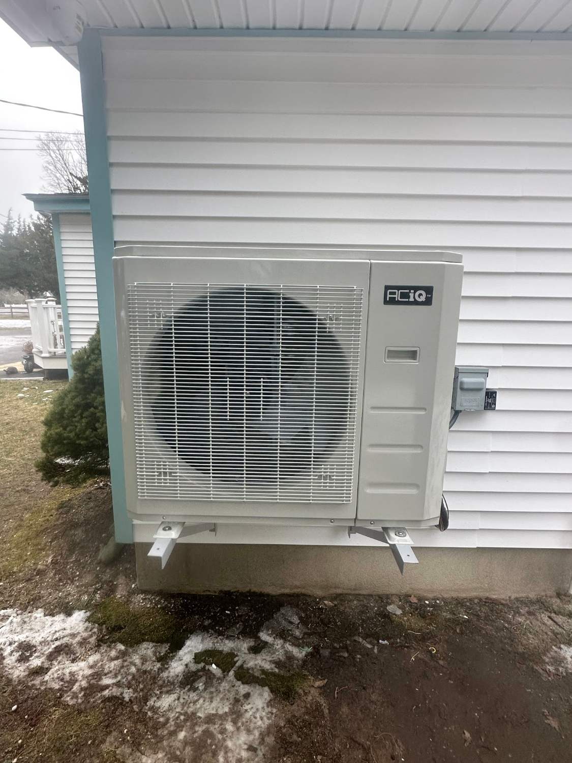 New outdoor mini-split condenser mounted on the siding of a Cape May NJ home