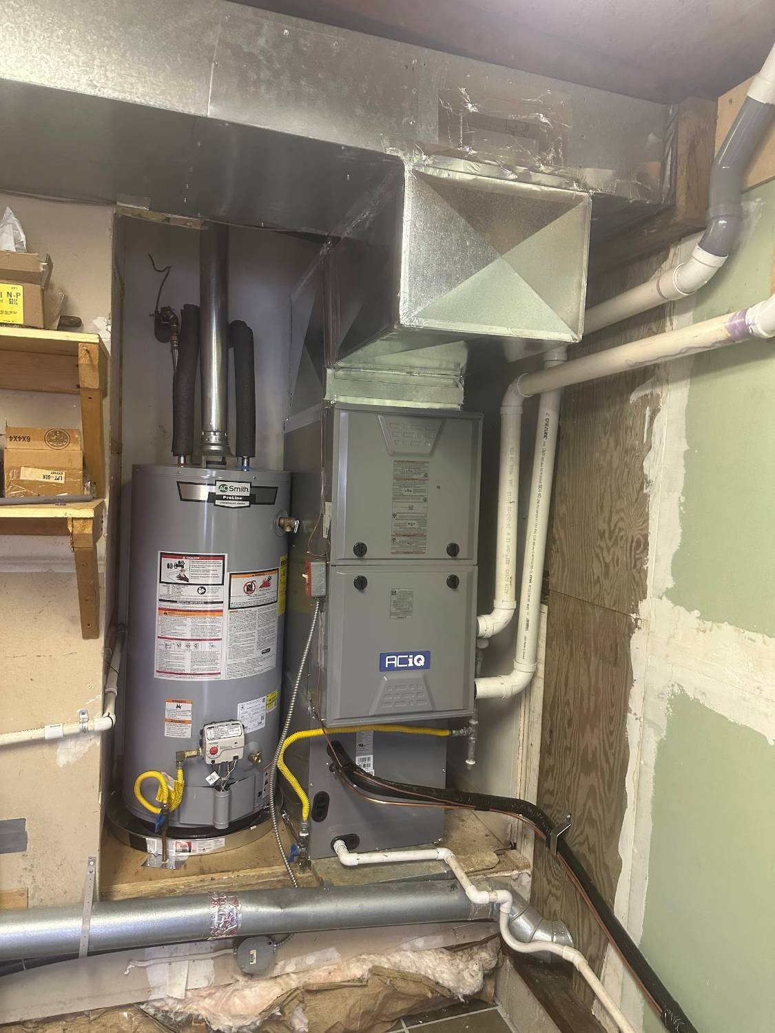 Furnace and water heater in a utility closet during a Comfort Pro repair visit