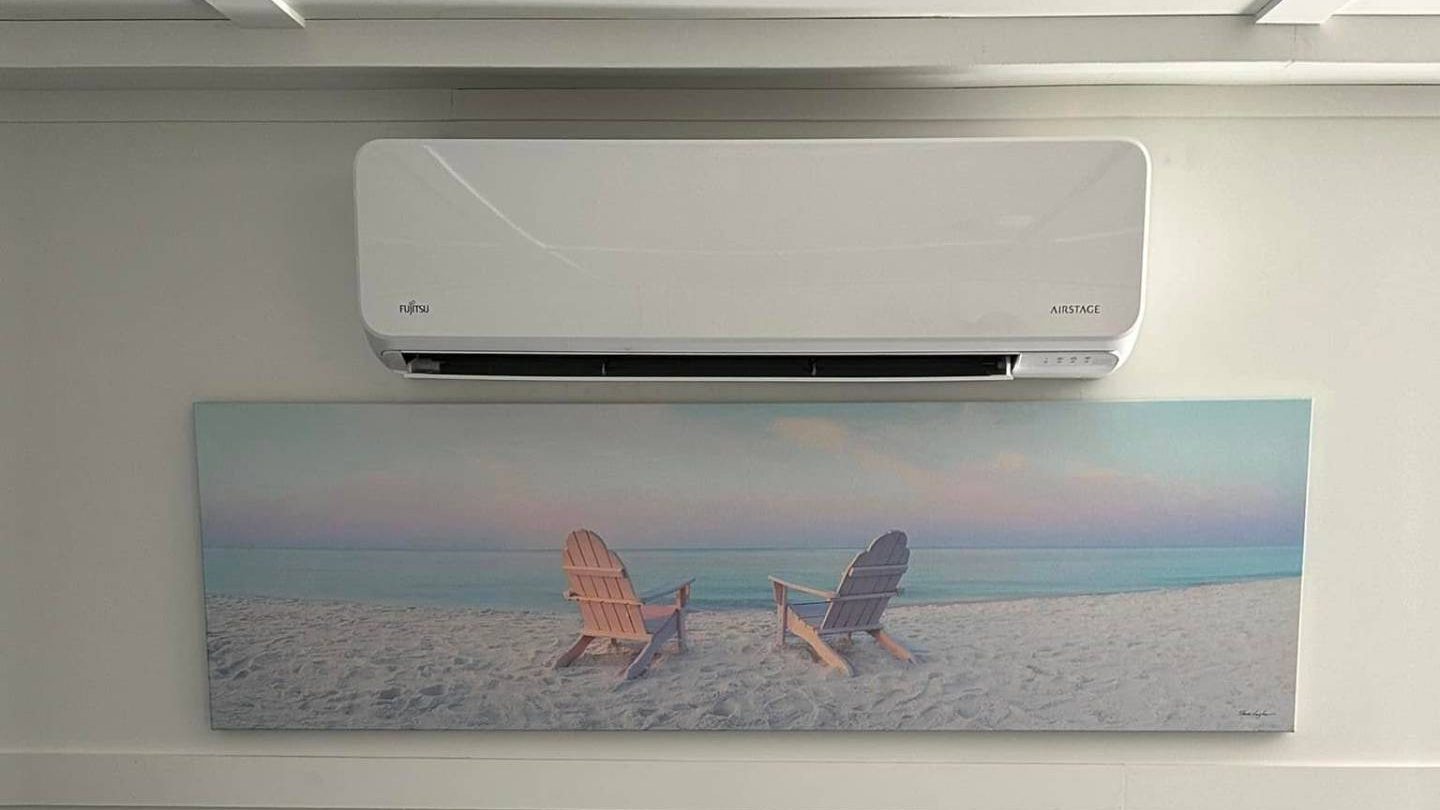 Fujitsu Airstage wall unit above a beach canvas in a Cape May County shore living room
