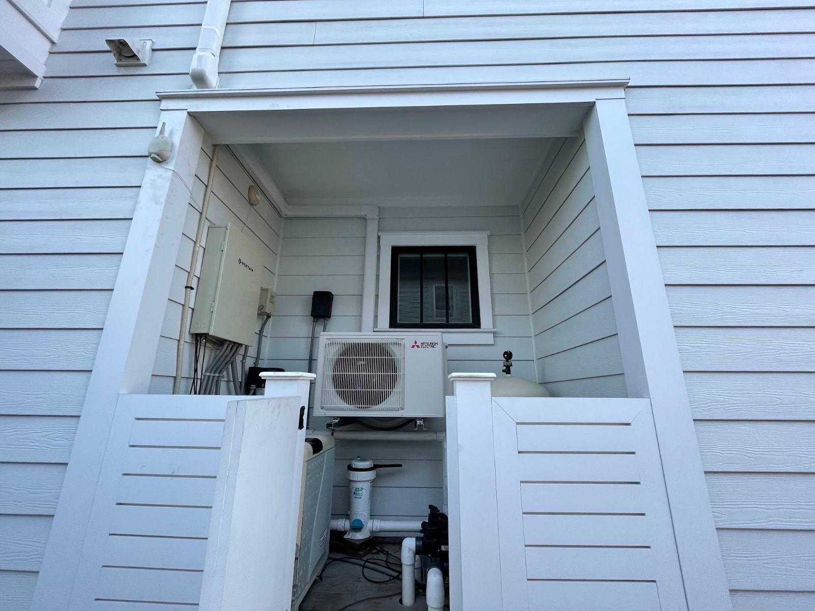 Ductless mini-split condenser inside a white enclosure at an Ocean City NJ shore home