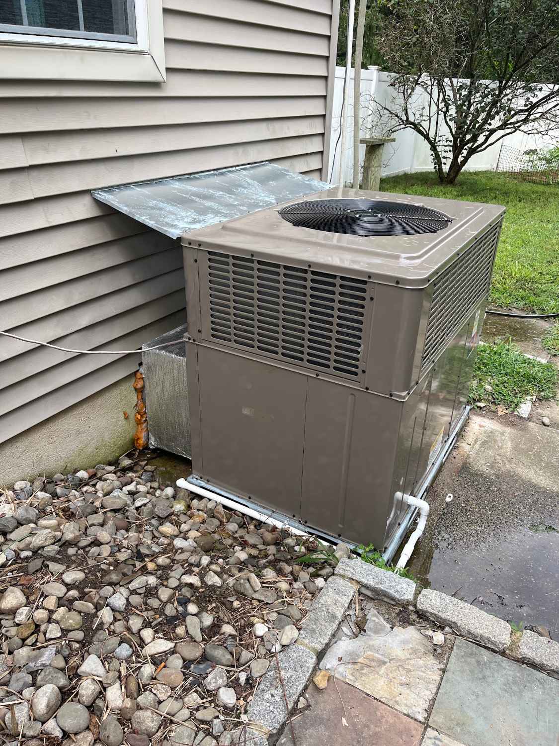 Packaged heating and cooling unit installed beside a home in Stone Harbor NJ